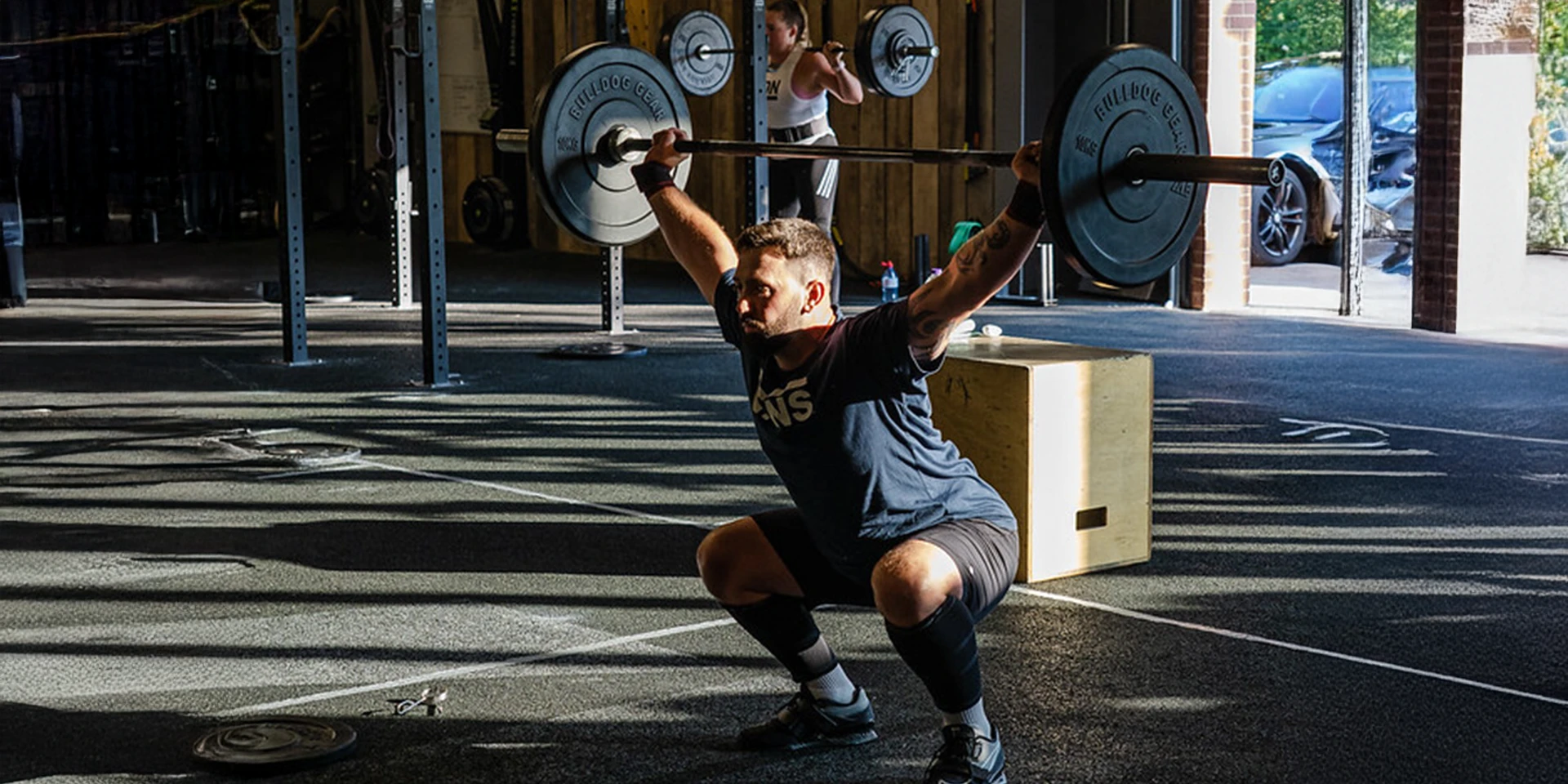 man lifting weights at TRAIN MANCHESTER