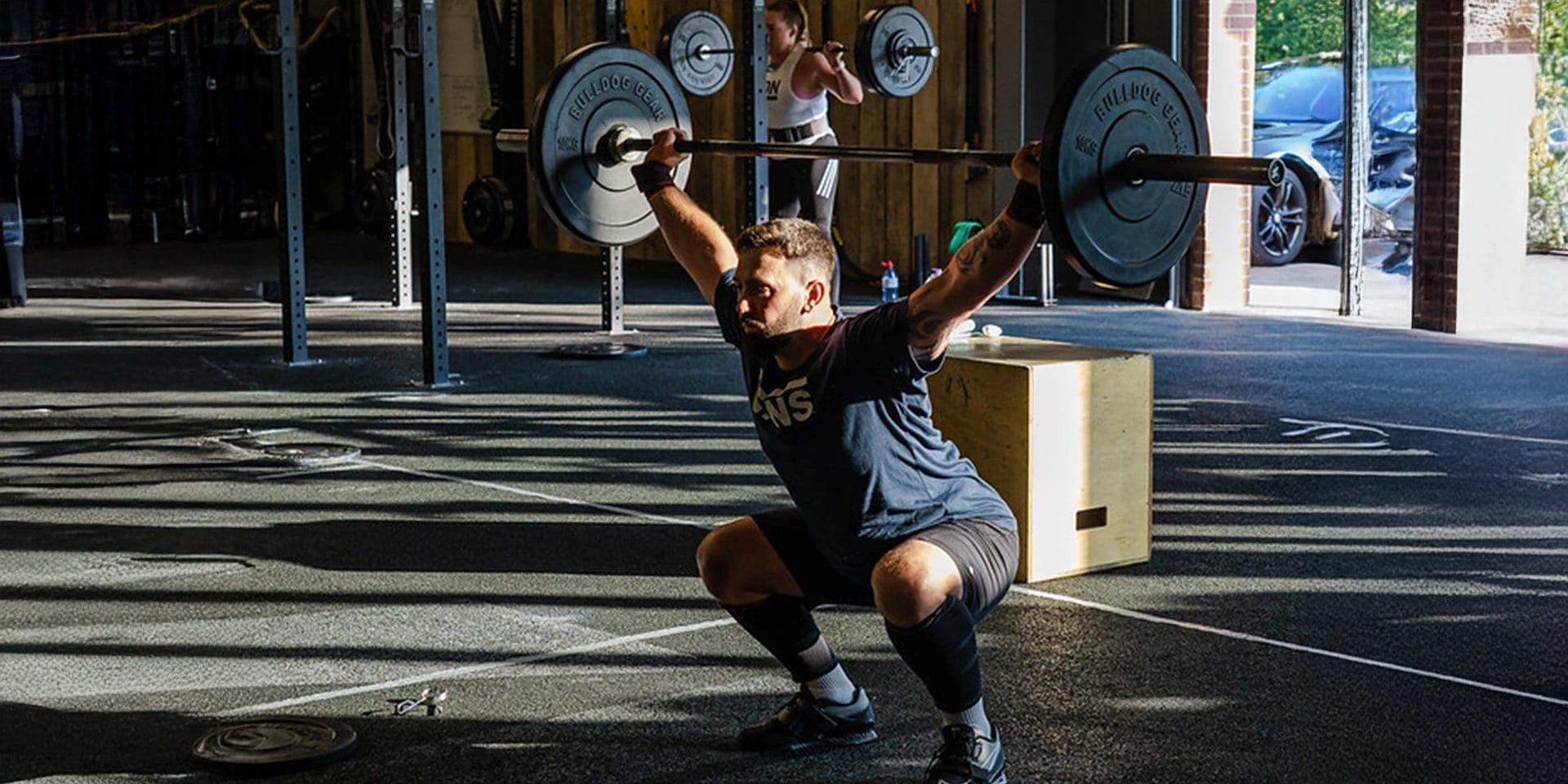 man lifting weights at TRAIN MANCHESTER