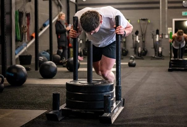 man in white shirt doing Hyrox in Manchester